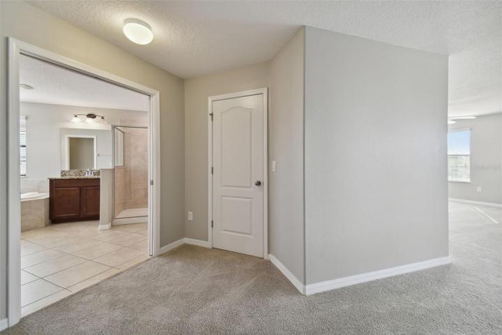 View of the ensuite with the door to the right being a walk-in closet.