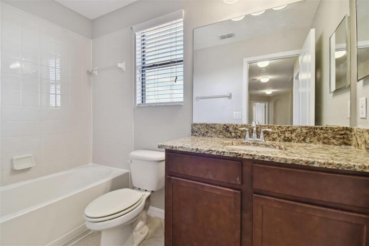 Bathroom 3 with granite sink and tub.