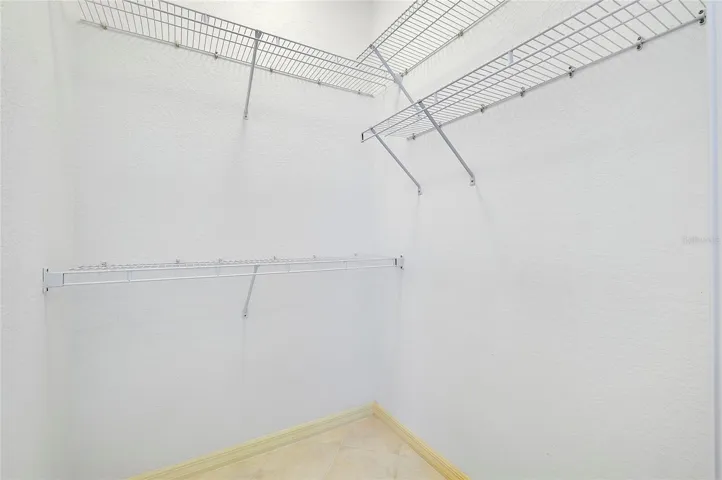 Primary His & Her Walk In Closet