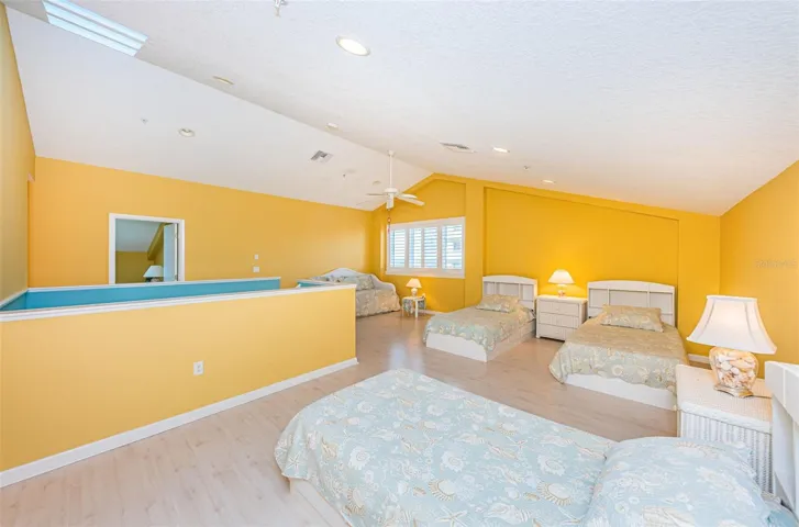 .. 2nd Level : Main Bedroom has 21 ' by 20 ' of Bedroom  Space - with 3 Beds and a Trundle Bed to Left in Photo. NOTE: Owners Usually Have the Trundle Bed Downstairs on Main Floor  in Guest Bedroom with Yoga Mat.