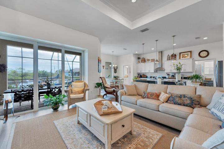 Living Room overlooking pool & Lanai with canal in the background.