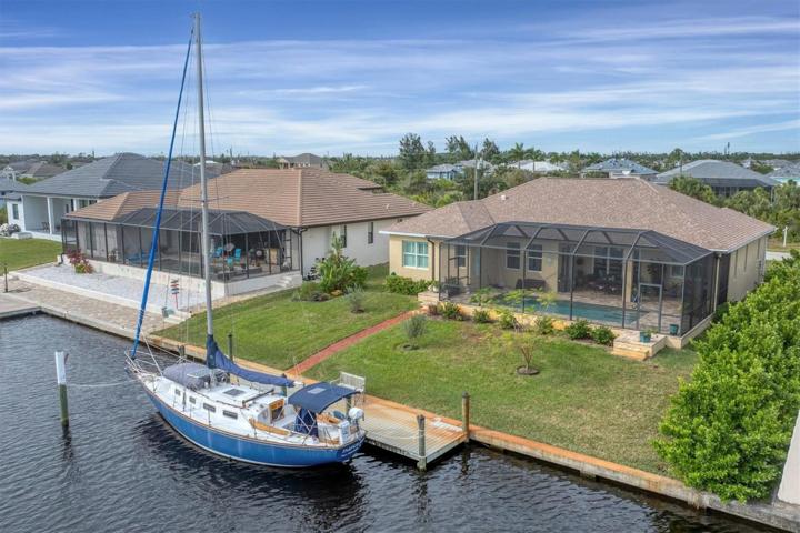 Aerial View of rear of home, boat dock & canal.