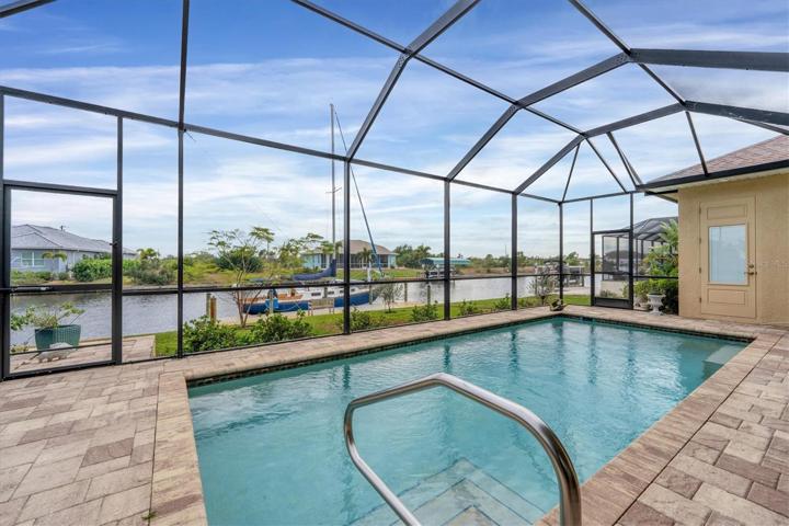 Screened in pool & lanai overlooking the boat dock & canal.