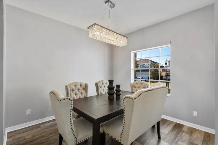 Formal Dining Room with updated light fixture/chandelier and luxury vinyl plank flooring
