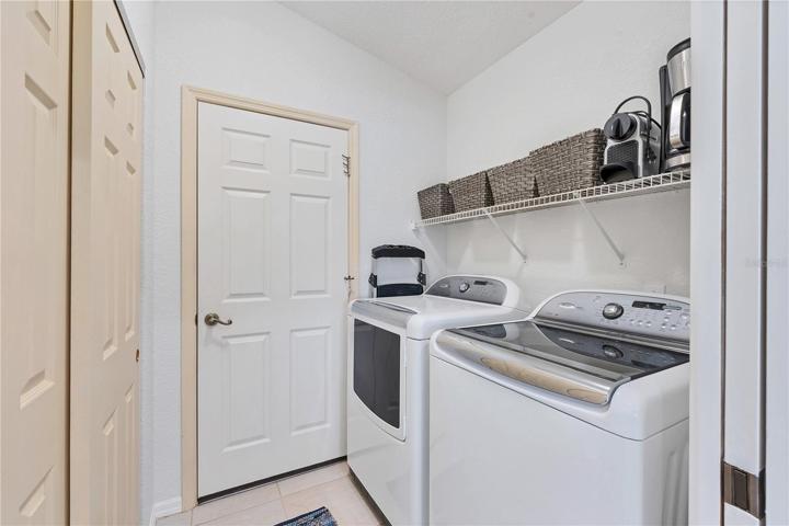 The laundry room has a large wall closet pantry and pocket door to close off from the kitchen