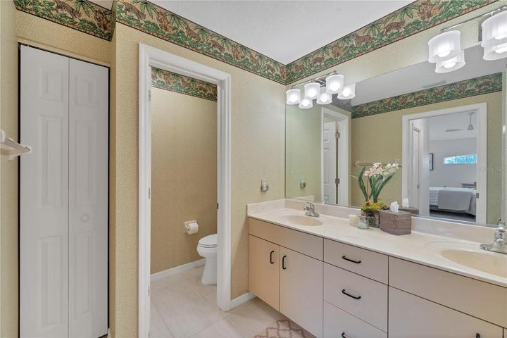 The linen closet and lots of storage with sink cabinets