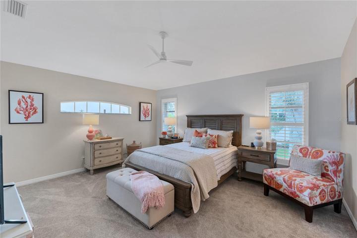 The master bedroom has plantation shutters, direct access to the lanai and has a walk in closet.