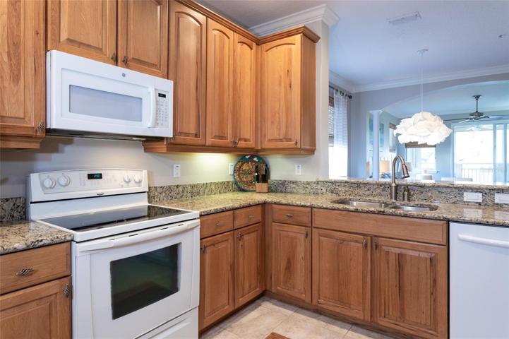 Nicely Appointed Kitchen With Wood Cabinets And Granite Counters