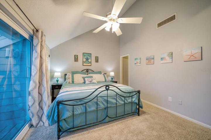 Primary bedroom leading to closet and ensuite bathroom