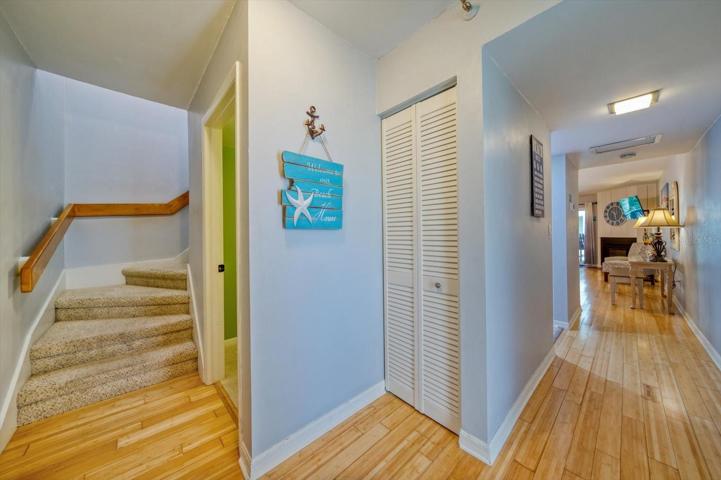 Entryway with storage, half bath and stairs to upper floor.