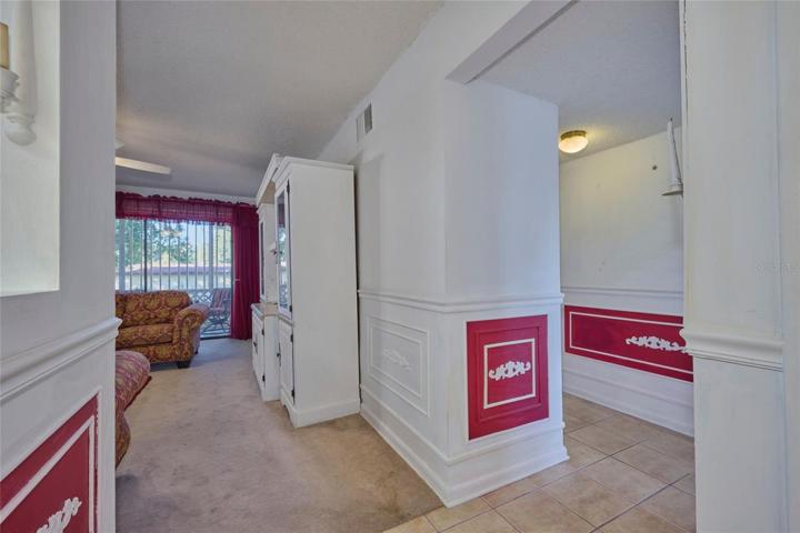 Ahead is the living room and down the hall are the bedrooms