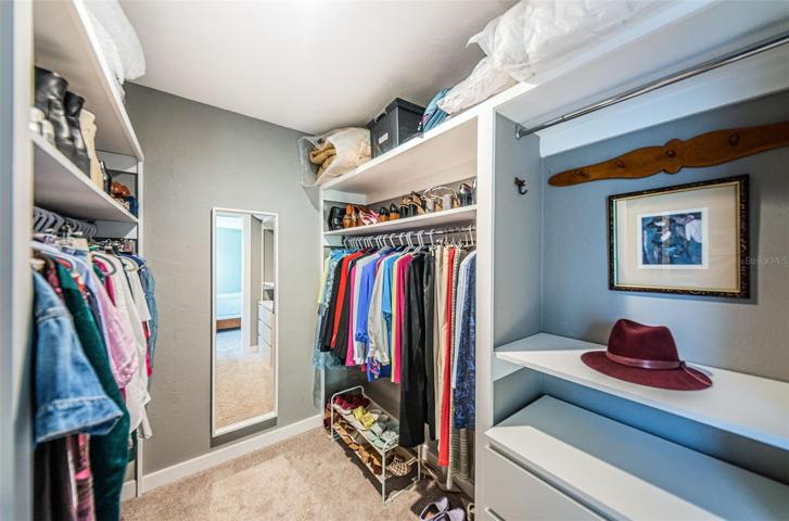 One of two walk in closets in the primary bedroom.