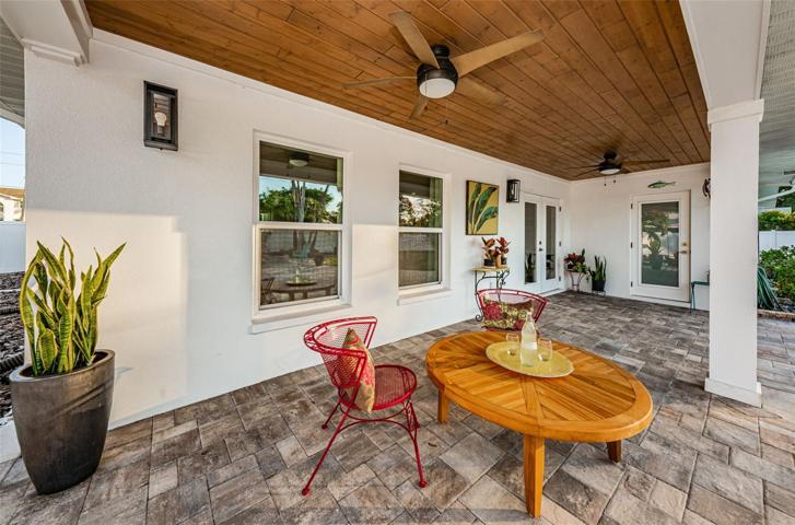 Wood plank ceiling on the outdoor patio adds to the coastal vibe.