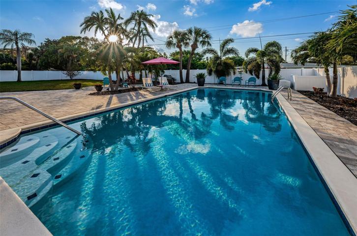 Huge pool graced by palms and lush landscaping.