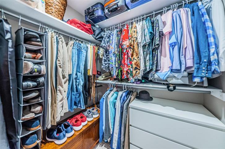 Two of two walk in closets in the primary bedroom.