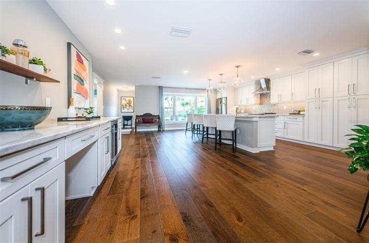 Beautiful wood floors grace the home. Shown here is the dry bar and work station.