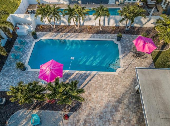 The large pool surrounded by artisan pavers and a firepit create the perfect entertainment space.