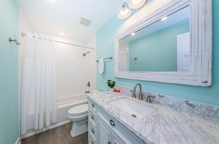 Shared hall bathroom with a tub is located between bedroom 2 and 3.