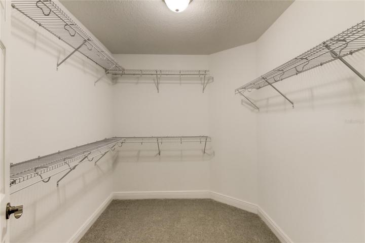1 of 2 walk-in closets for primary bedroom