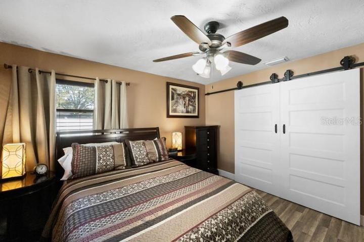 BEDROOM 1 WITH BARN DOOR CLOSET DOORS