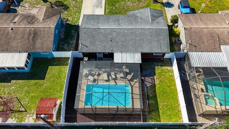 DRONE VIEW OF POOL AND BACK OF HOME