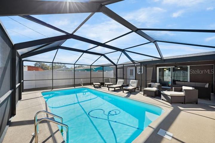 POOL SHOWING BACK DOOR AND SLIDERS INTO FAMILY/LIVING AREA