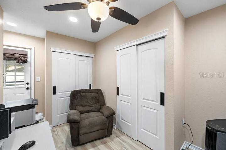 BEDROOM 3 SHOWING BACK DOOR TO LANAI AND CLOSET FOR STORAGE