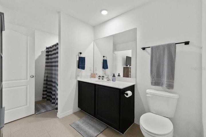 Owners ensuite bathroom featuring a walk-in closet, and a large walk-in shower.