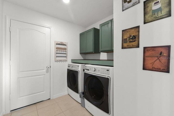 Laundry room with custom cabinets and counter.