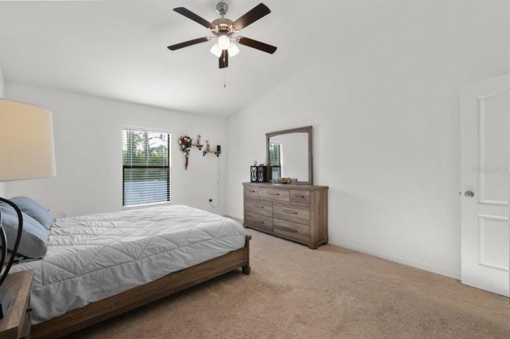Owners suite featuring a walk-in closet, and ensuite bathroom.