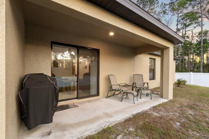 Covered lanai overlooking the huge fenced-in back yard.
