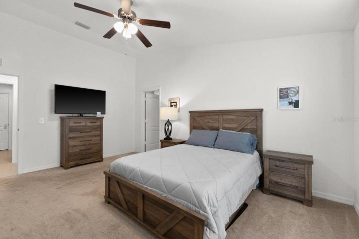 Owners suite featuring a walk-in closet, and ensuite bathroom.