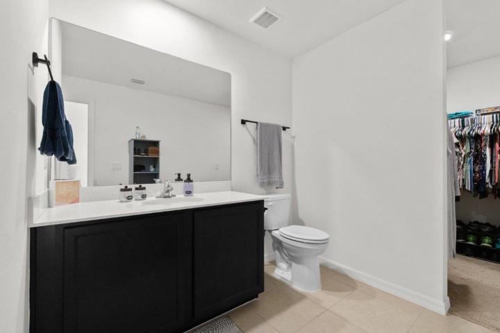 Owners ensuite bathroom featuring a walk-in closet, and a large walk-in shower.