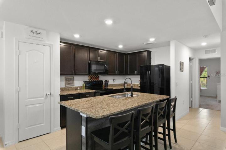 Spacious kitchen featuring ample cabinetry, granite countertops, newer appliances, and a large island with breakfast bar!