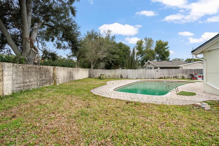 Oversized back yard features a full size pool.