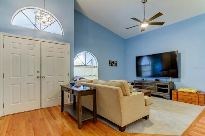 Living entry with vaulted ceilings and new tile flooring