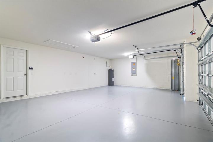 Garage showing water heater & hurricane shutters