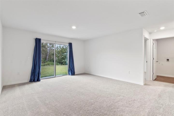 Great room with slider to back yard (laundry room to right)