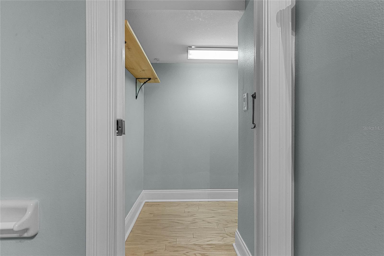 large storage closet off powder bath and laundry area