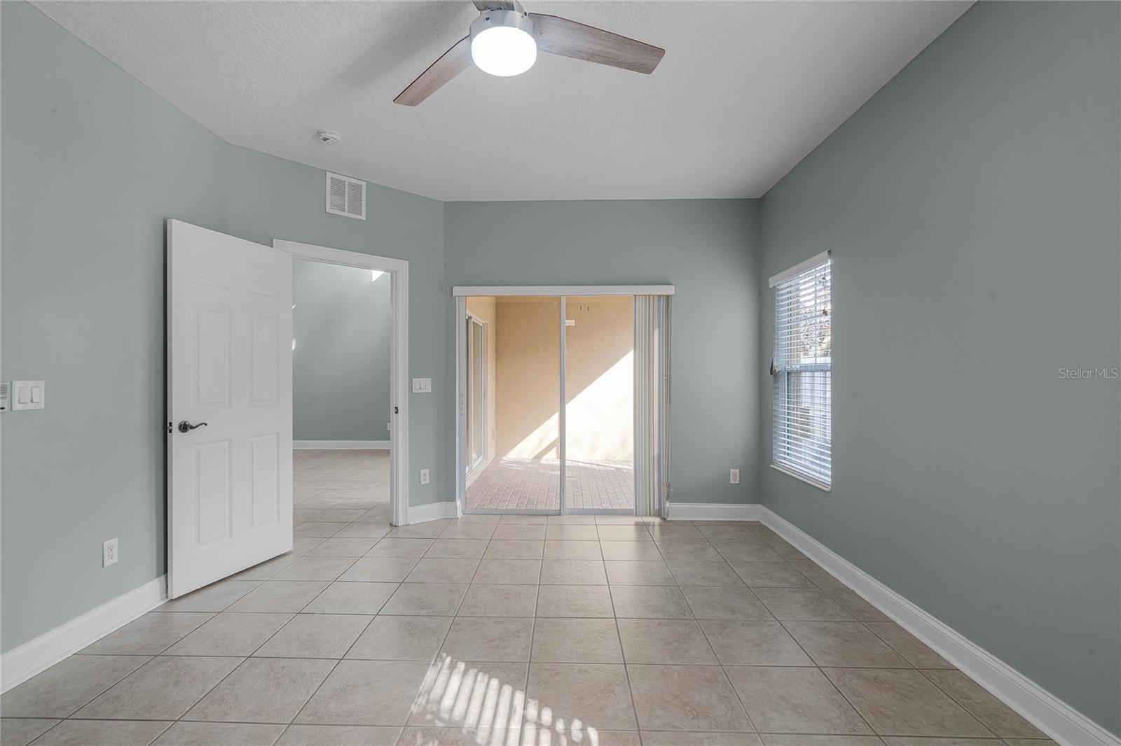 Primary bedroom with sliders off to patio
