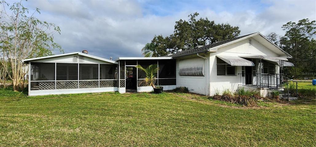 Main house on right, covered carport in center connecting monther-in-law suite