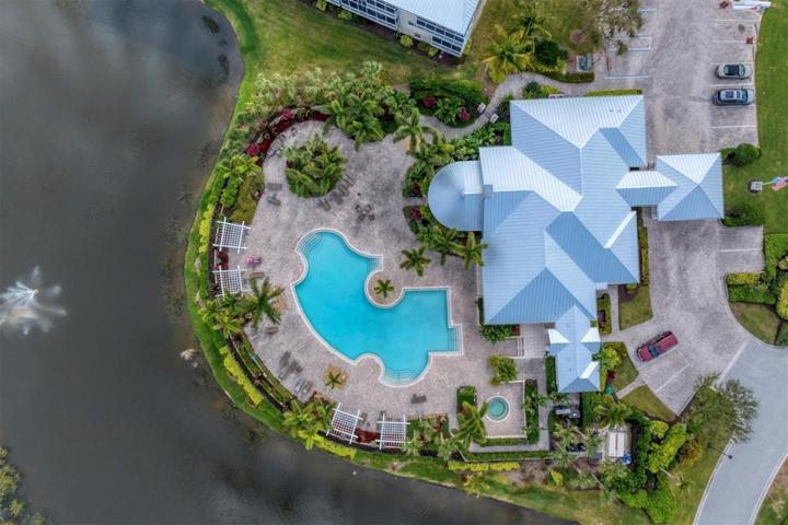 Clubhouse & Pool overlook a lake with fountain