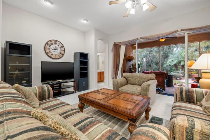 Family room with view to sliders that open to the lanai and the beautiful garden and conservation area