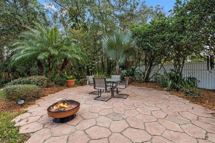 Outdoor entertaining area with pavers and view to the garden