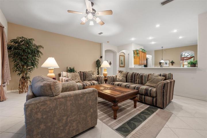 Family room with view to sliders that open to the lanai and the beautiful garden and conservation area