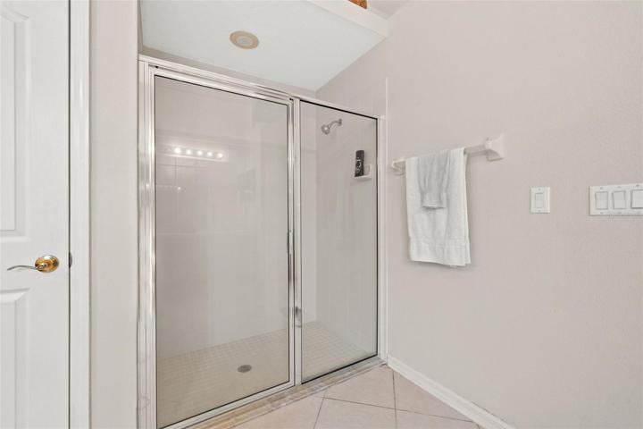 Primary bathroom with walk in shower, soaking tub and dual vanities