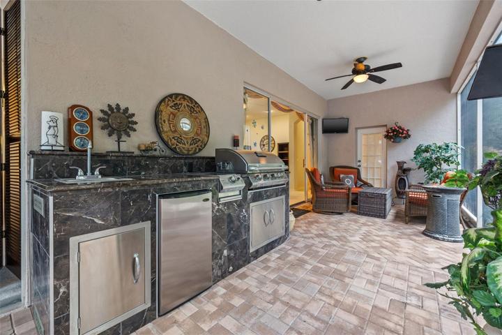 Outdoor gas grill kitchen.  Sliders open up from the family room and primary bedroom