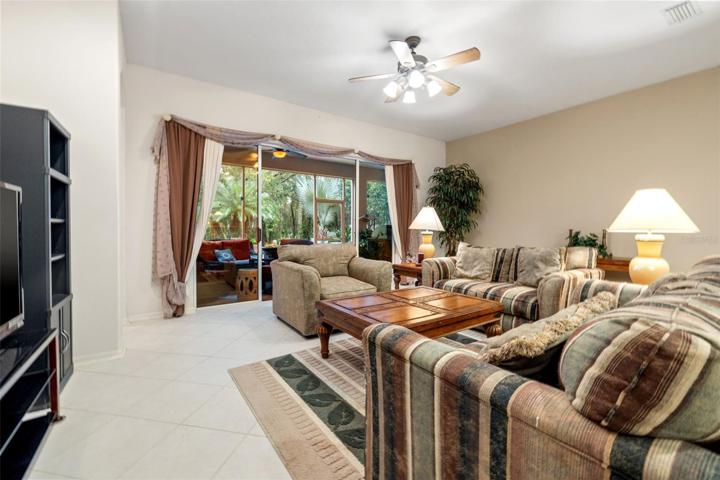Family room with view to sliders that open to the lanai and the beautiful garden and conservation area
