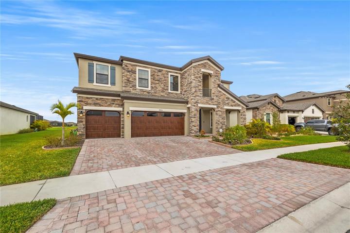 Stunning front View of this gorgeous 5 bedroom 4 bath 3 car garage on a community lake