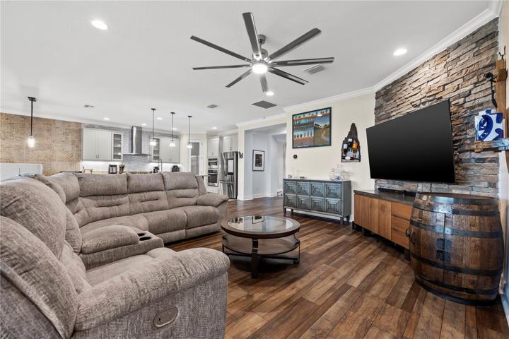 Family room with sliders to rear porch and community pool